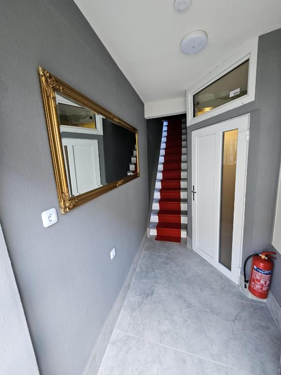 a stairway with a mirror and a red staircase at Asanov Retreat in Northeim