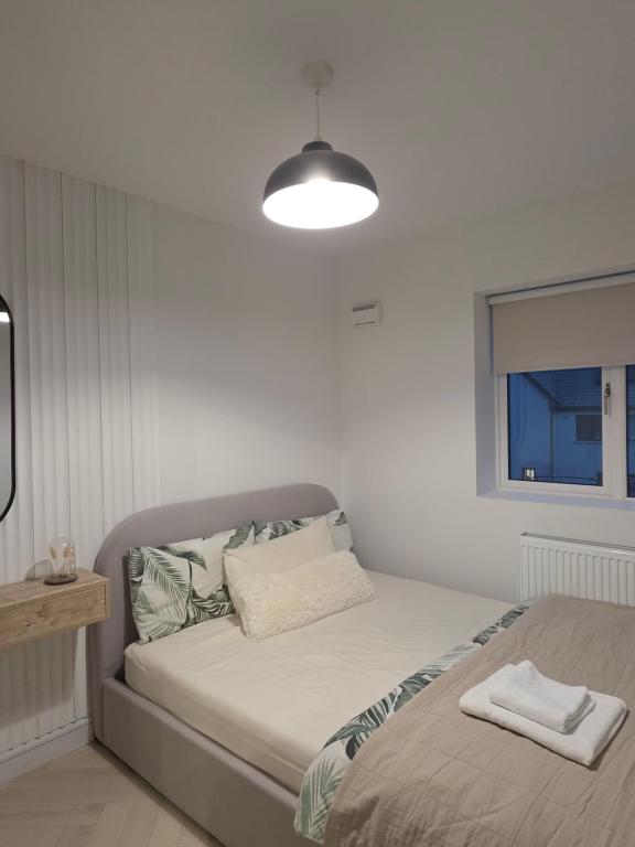 a bedroom with a bed with a lamp and a window at The Boulevard in Dublin