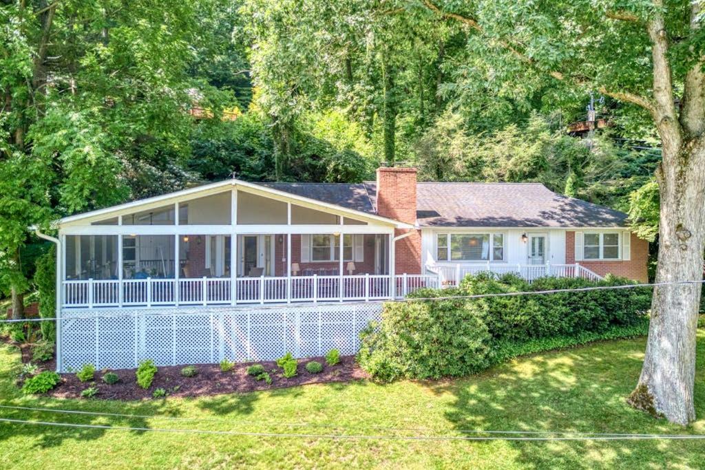 a home with a white house with a tree at Cameron Lakeside in Lake Junaluska