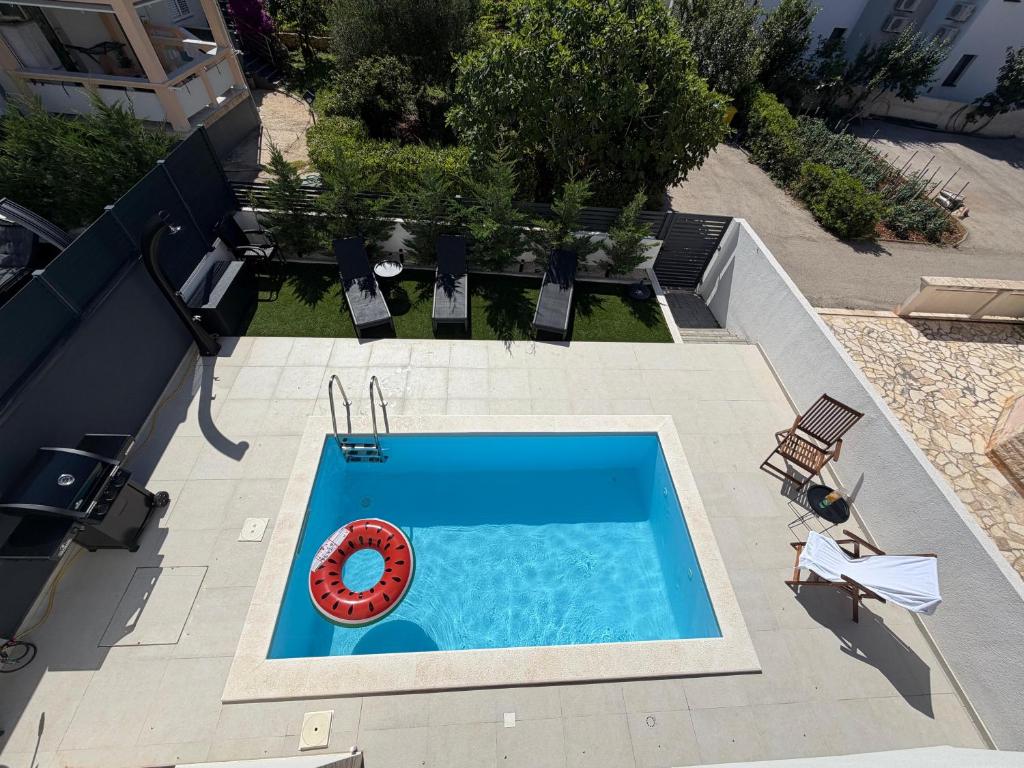 an overhead view of a swimming pool with a red lifesaver at Luxury Villa Rubi Vir - private pool in Vir