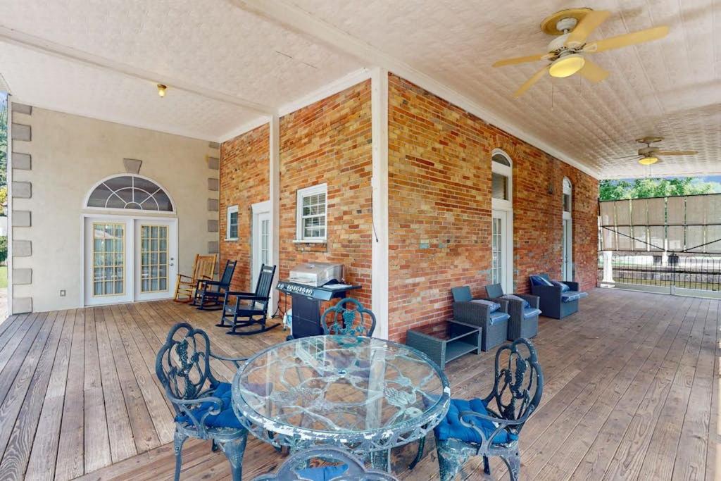 a patio with a table and chairs and a brick wall at Mountain Stream Haven in Whittier