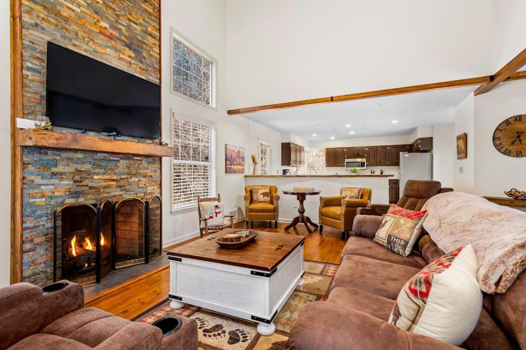 a living room with a fireplace and a tv at Cherry Tree Lodge in Black Mountain