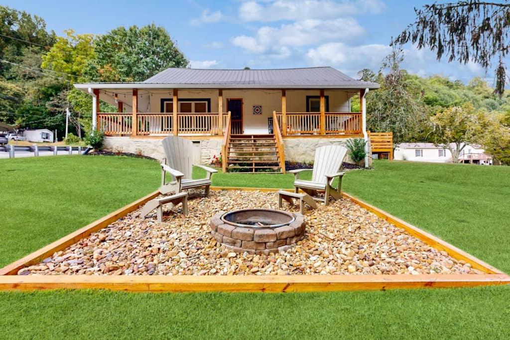 a house with two chairs and a fire pit in the yard at Meet Me At The Creek in Whittier