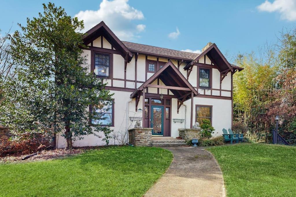 a large white house with a green yard at Love Lane Tudor in Waynesville
