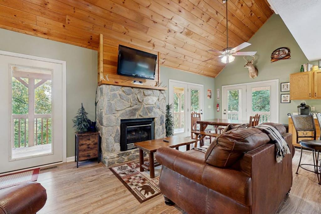 a living room with a couch and a fireplace at Smoky View Retreat in Maggie Valley