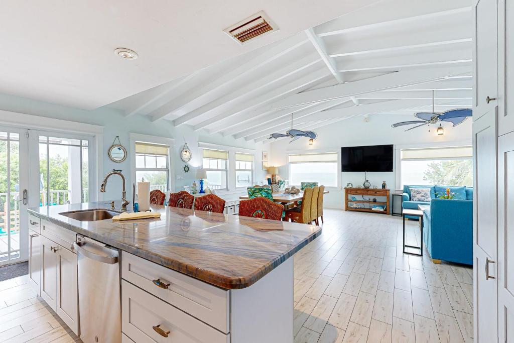 a kitchen with a counter and a living room at MA05 Bayfront Sunset Oasis in Marathon