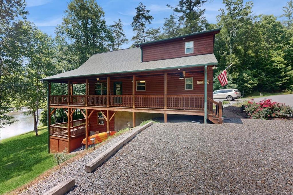 a large wooden house with a large deck at Talking River Chalet in Murphy