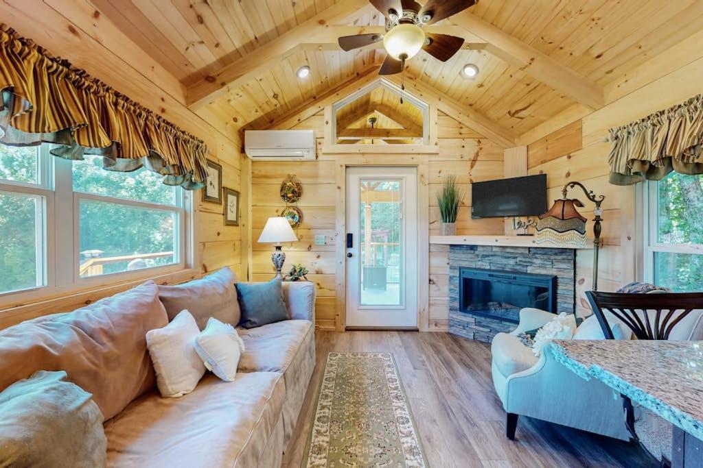 a living room with a couch and a fireplace at Deimos Cabin in Mars Hill
