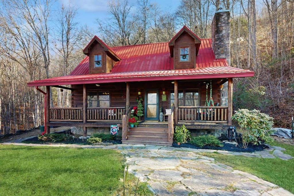 a log cabin with a red roof at Bear Hug in Sylva