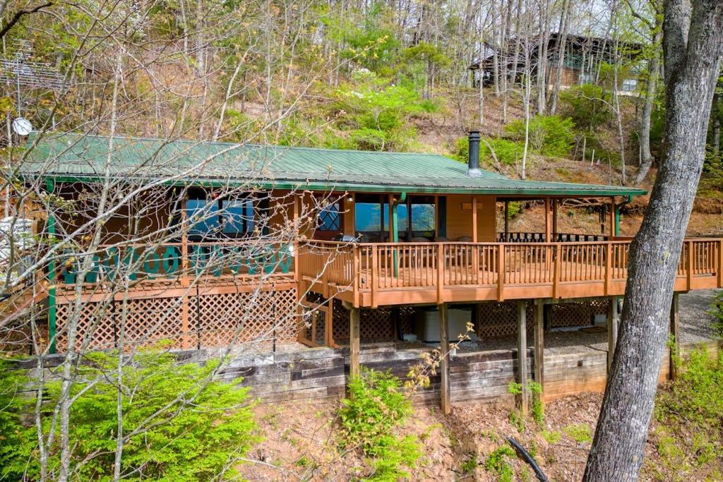 a large wooden house with a green roof at Black Bear Cabin Fox Mountain in Franklin