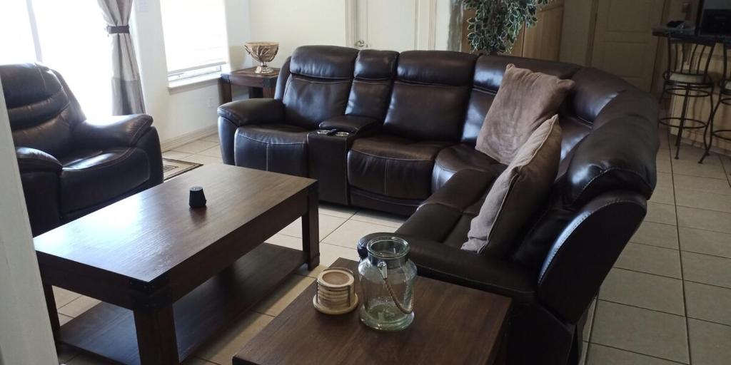 a living room with a leather couch and a coffee table at Relaxing comfort house nice equiped in Pharr