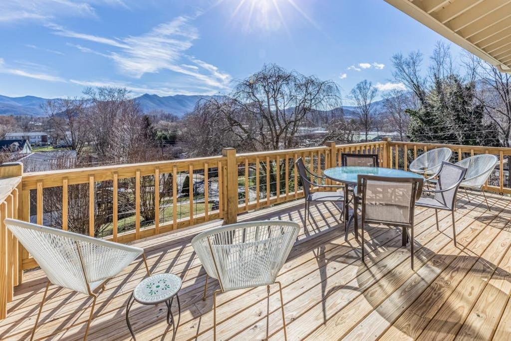a deck with chairs and a table with a view at The Willows in Waynesville