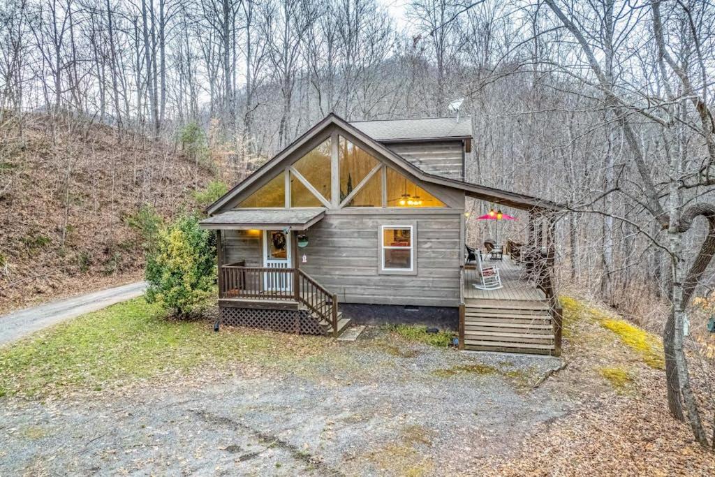 a small cabin in the woods with a porch at Tree Top Cabin in Sylva