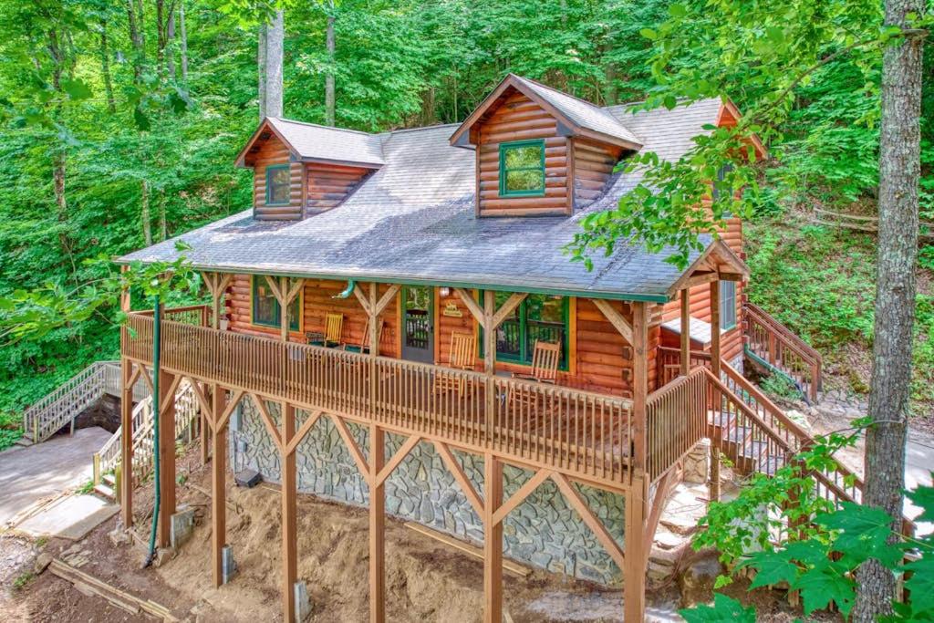 a log cabin in the middle of the woods at Forest Hideaway in Maggie Valley