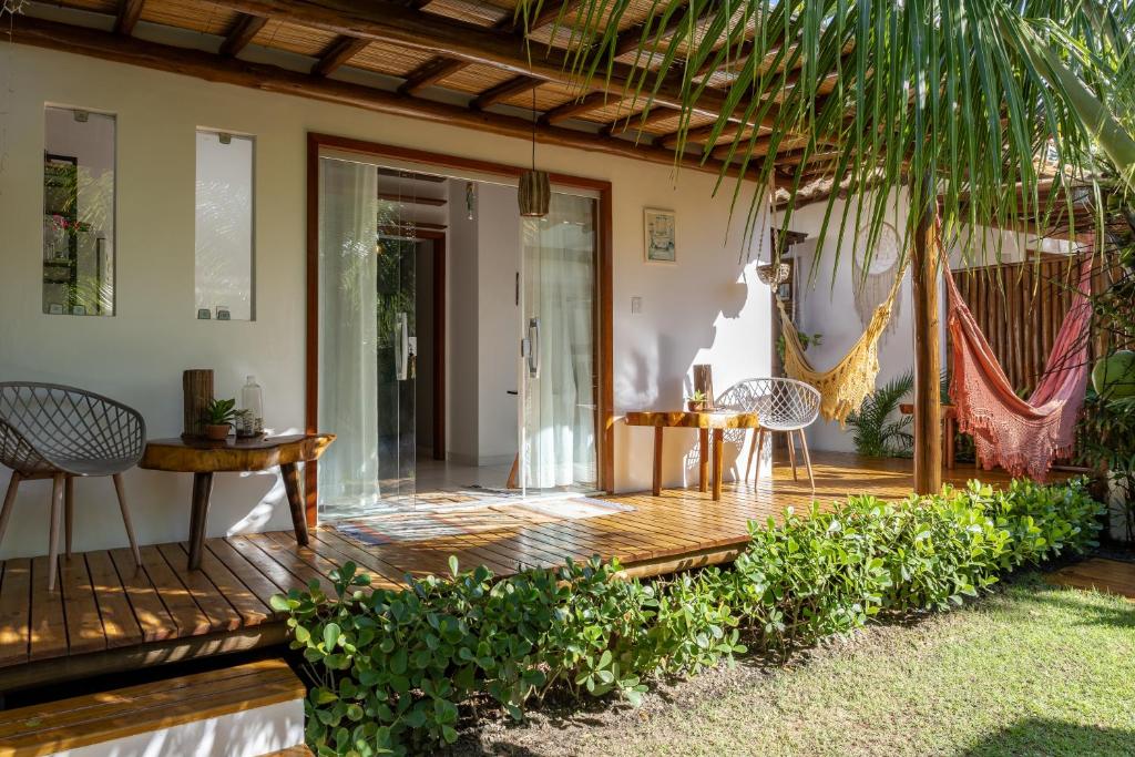 a wooden deck with chairs and a table on a house at Casa Cuca Fresca , 2 Suítes e a 400m das Piscinas Naturais reservadas in Marau