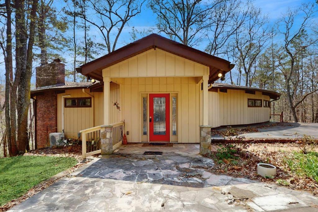 a small yellow house with a red door at Red Fox Lair in Franklin