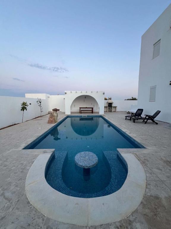 a swimming pool in the middle of a building at villa mellita in Mellita