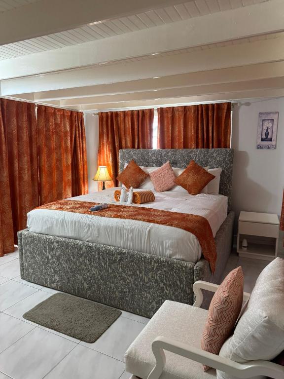 a bedroom with a large bed with red curtains at Mystic Ridge Ochi in Ocho Rios
