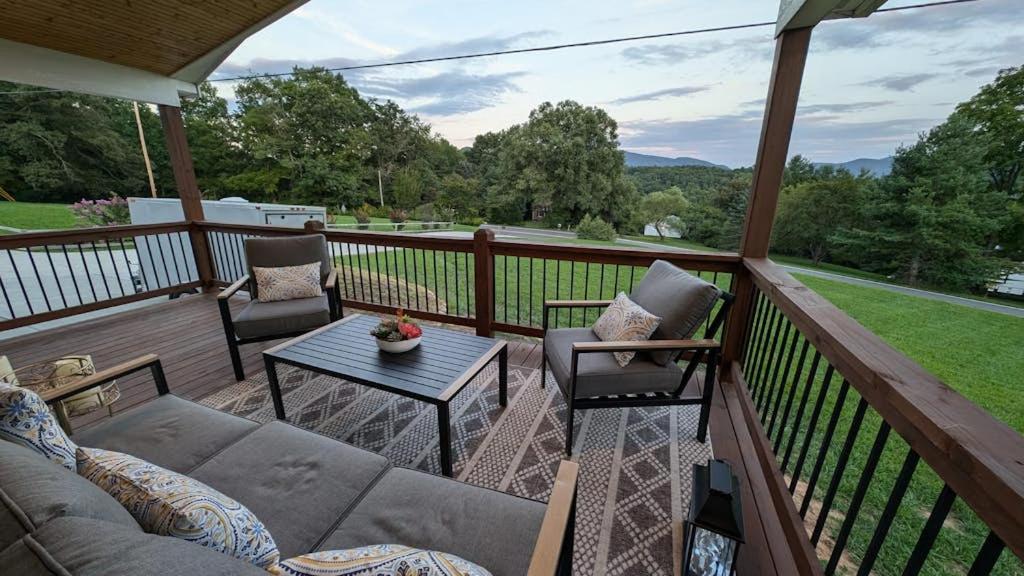 a porch with a couch and chairs and a table at Blueridge Brew View in Fairview