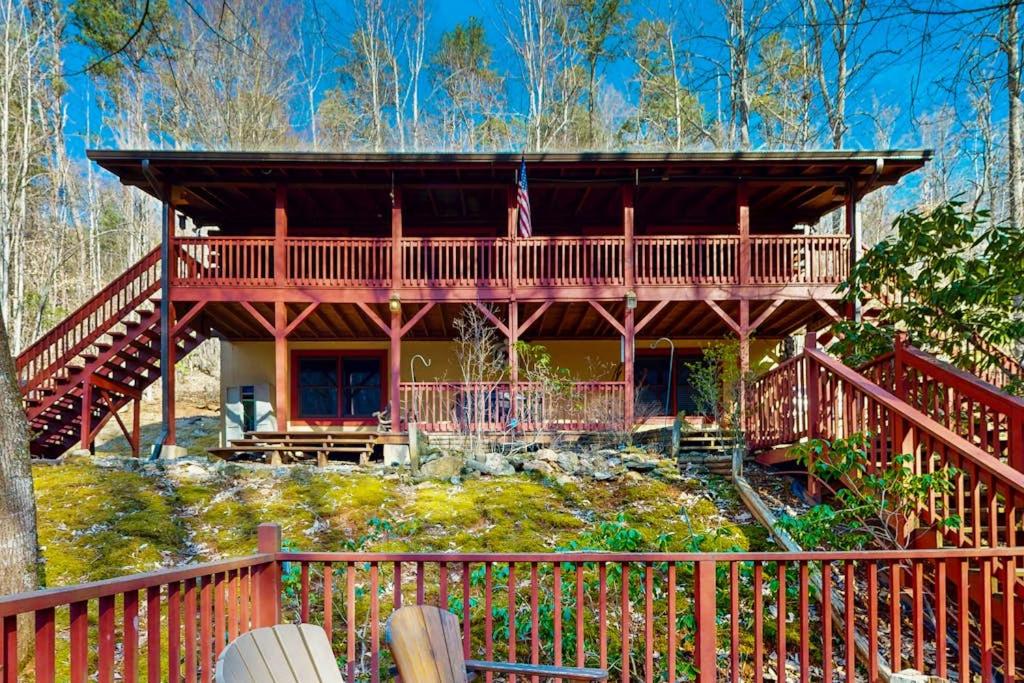a large wooden house with a flag on it at Moose Creek Lodge in Sylva