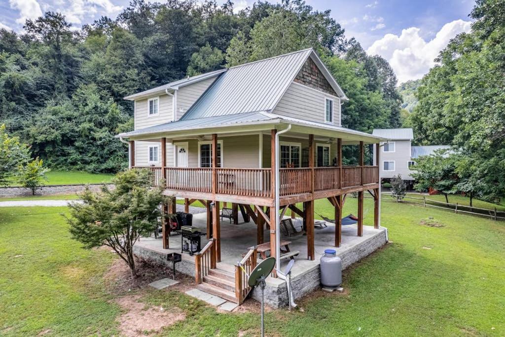 a house with a large deck on a lawn at Full Stream Ahead in Whittier