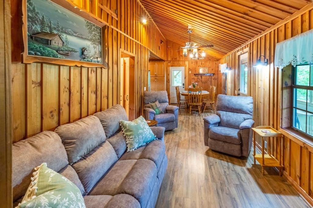 a living room with a couch and two chairs and a table at The Outpost in Whittier