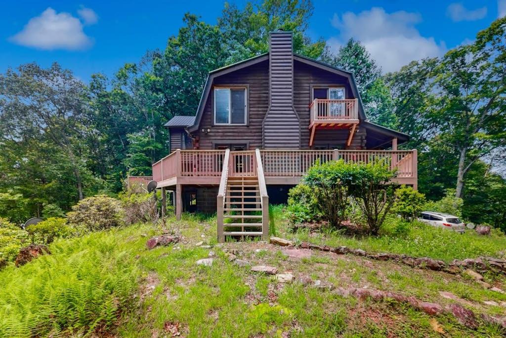 a house on a hill with a deck at Walela Cabin in Topton