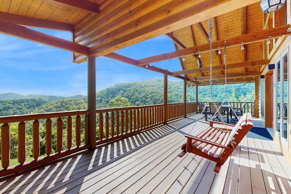 a deck with benches and a view of the mountains at Slice of the Mountain in Franklin