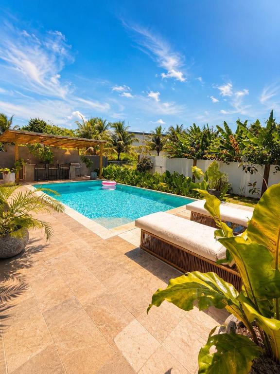 a swimming pool in a backyard with trees and plants at Villa costa mar in Cabrera
