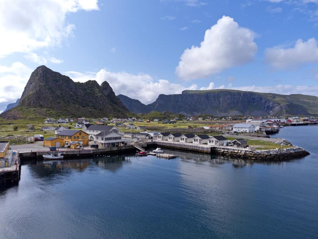 an aerial view of a harbor with houses and mountains at Værøy Brygge Hotell in Værøy