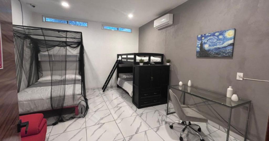 a room with two bunk beds and a glass table at reforma tecoman colima mexico in Tecomán