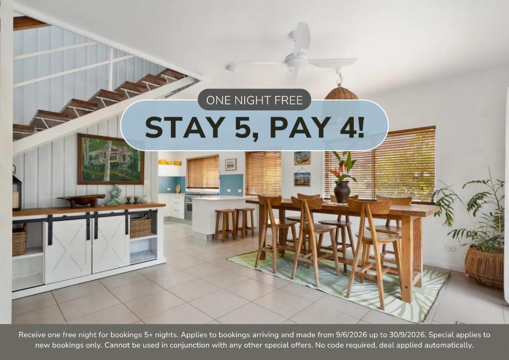 a kitchen and dining room with a table and chairs at Beach House on Pearl - Kingscliff Central in Kingscliff