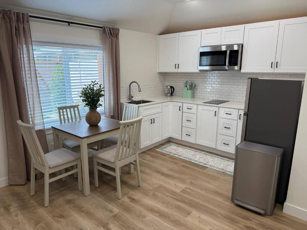 a kitchen with a table and chairs and a refrigerator at Modern Private Studio - Separate Entry in Edgewood