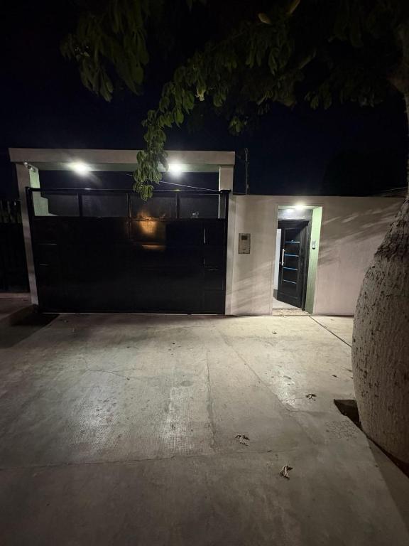 a building with a garage door at night at Alojamiento cuyum in Rivadavia