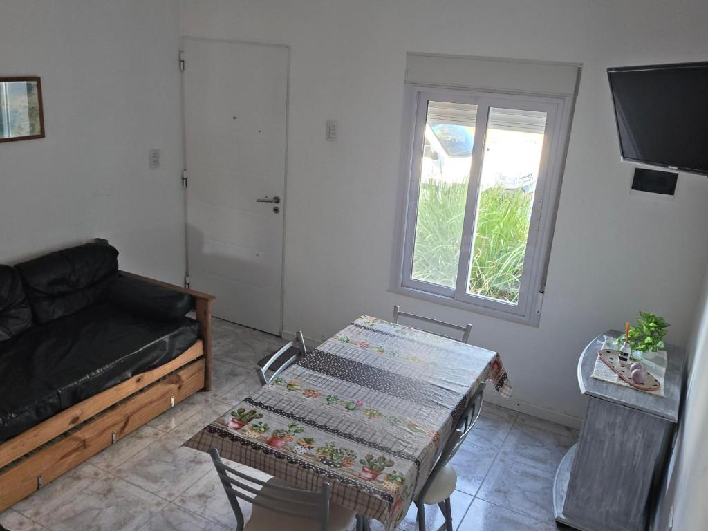 a living room with a couch and a table at CASA VERDE 1 depto in Carhué