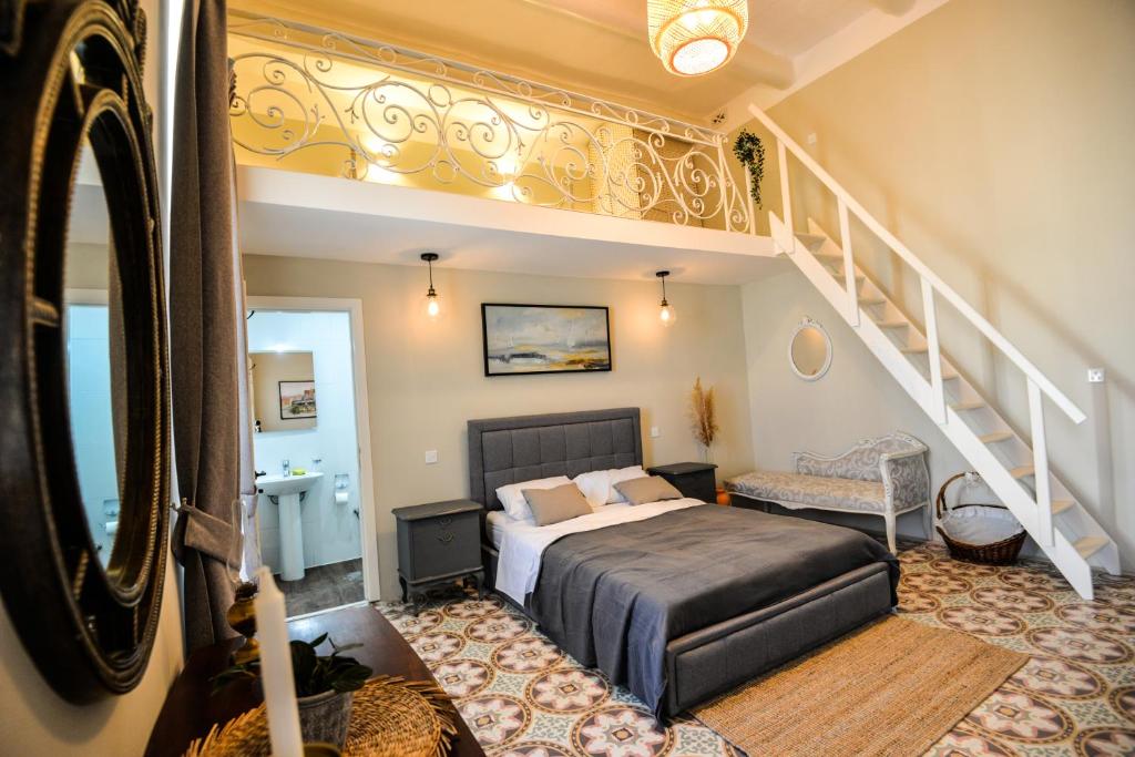 a bedroom with a bed and a staircase at Villa Dar Tfuliti in San Lawrenz