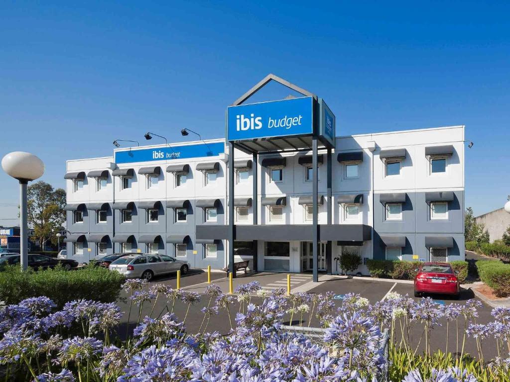 a white building with a sign on the front of it at ibis Budget - Dandenong in Dandenong