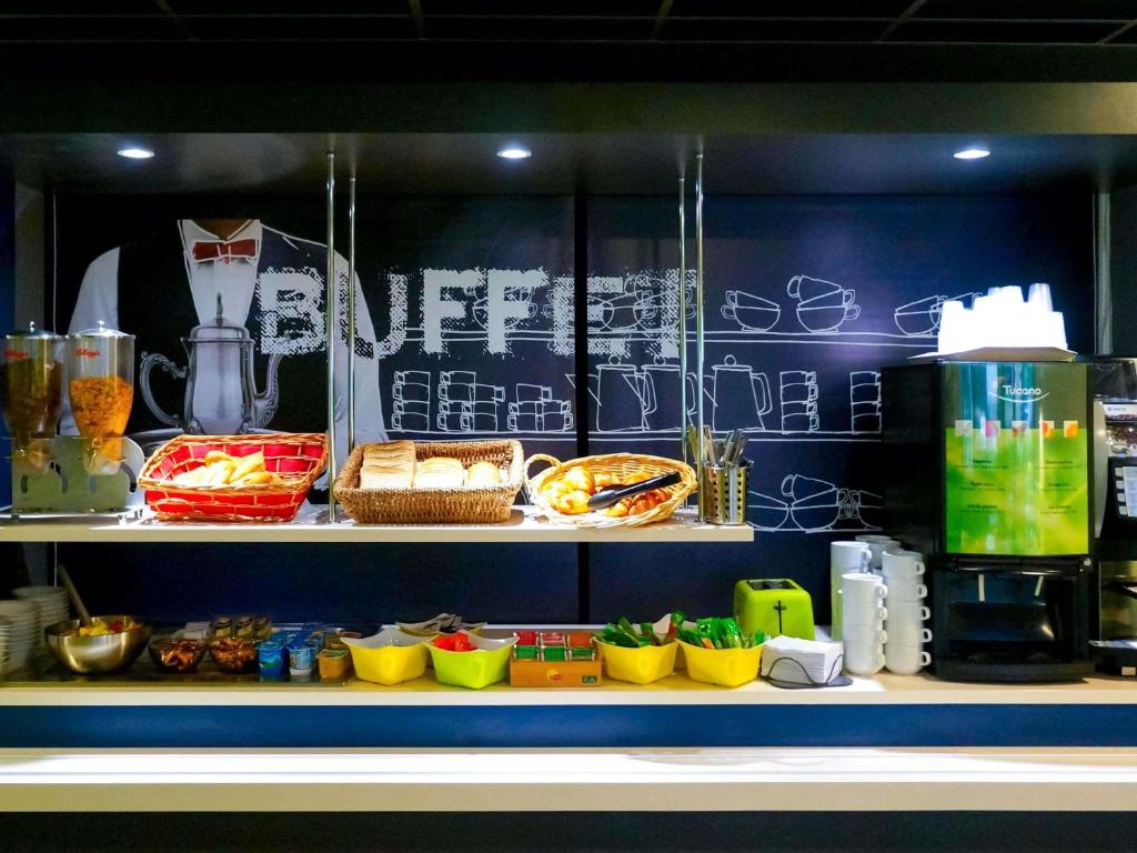 a counter with some food items on a shelf at ibis budget Metz Sud in Augny