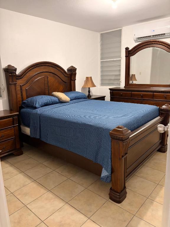 a bedroom with a bed with a blue comforter at josedith'sweet house in Isabela