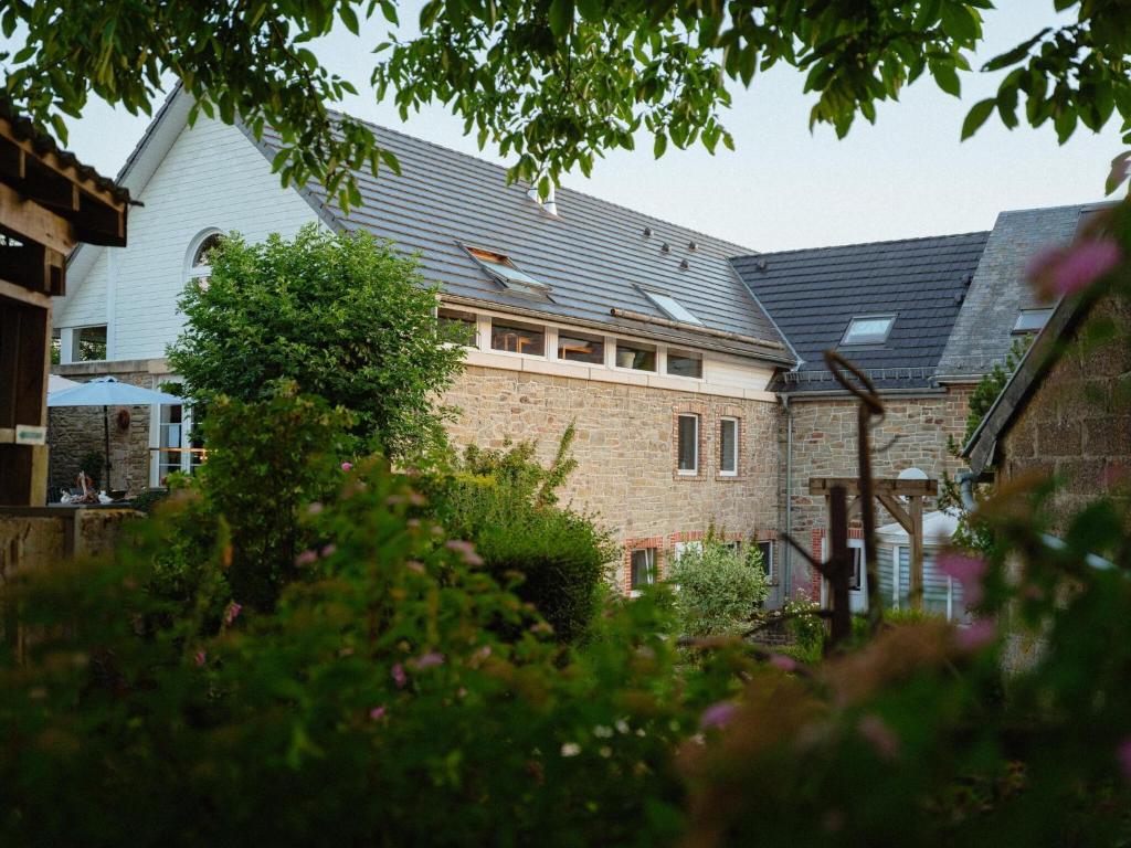 a house with a black roof on top of it at Group Getaway in Amel in Amblève