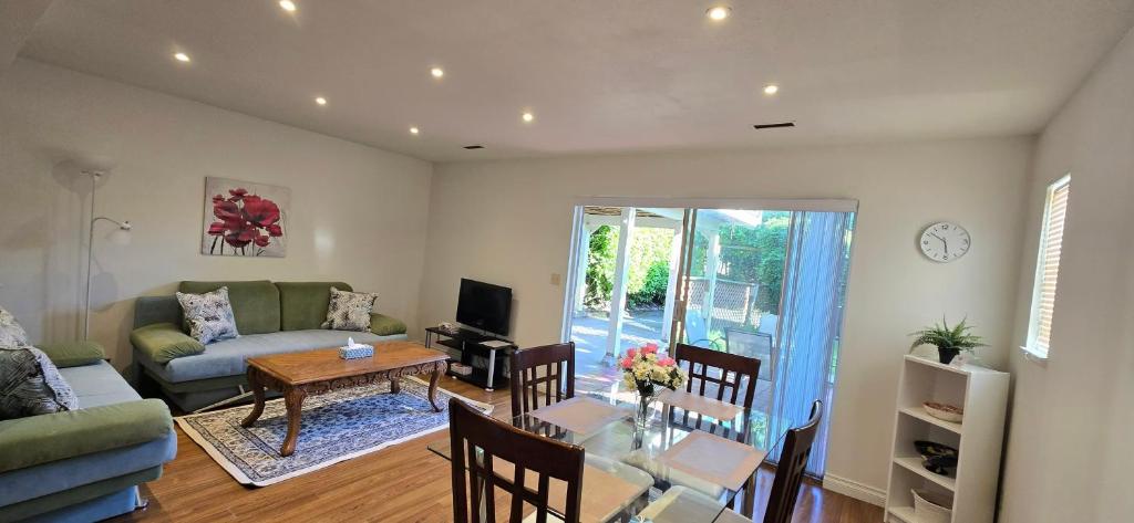 a living room with a couch and a table at Bright 2 BR, Great Location in West Vancouver