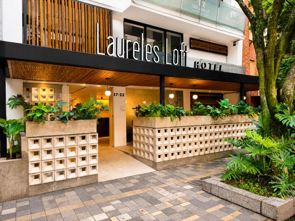 a store front of a building with plants at Hotel Laureles Loft in Medellín