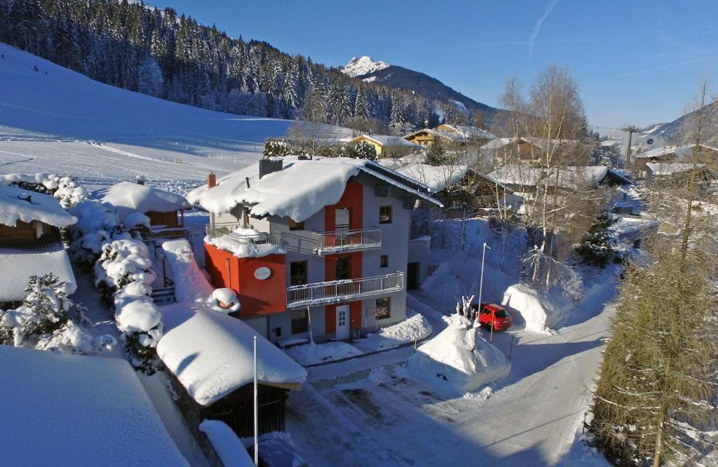 a house is covered in snow in a mountain at Birnhornblick in Leogang