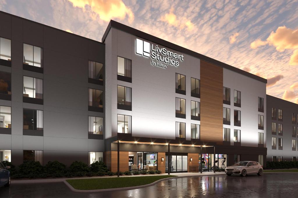 a rendering of a building with a car parked in front at Livsmart Studios By Hilton Clarksville in Clarksville
