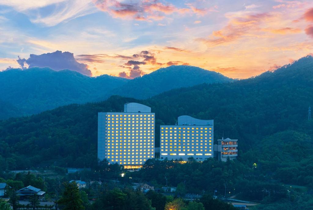 a view of a building with mountains in the background at Hilton Takayama Resort in Takayama