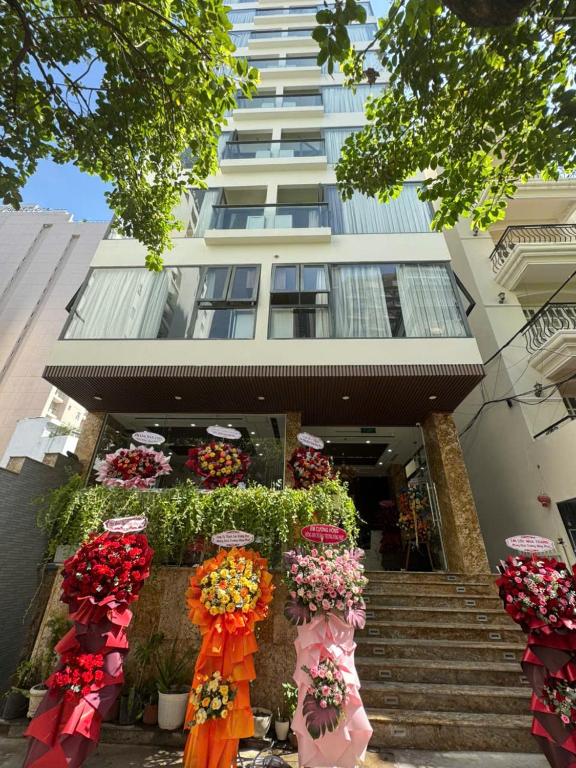 a building with a bunch of flowers in front of it at Amora Hotel in Nha Trang