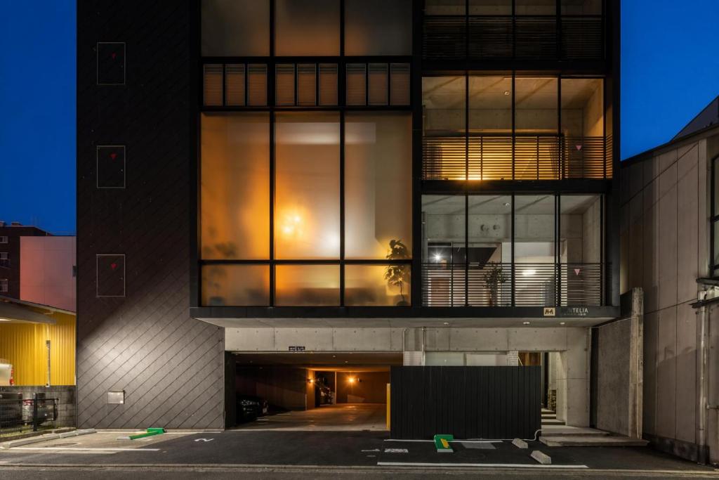 a building with large glass windows on the side of it at Huntelia Matsuyama in Matsuyama