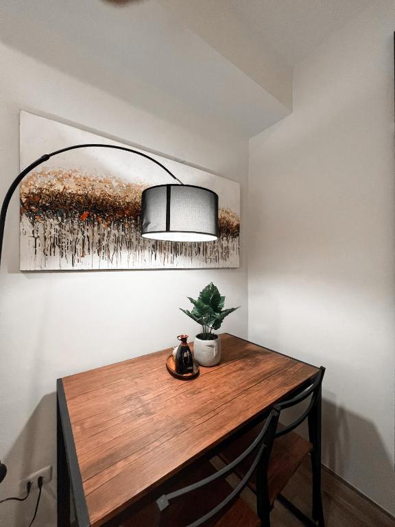 a table with a lamp and a plant on it at Zara at Mesavirre Bacolod in Bacolod