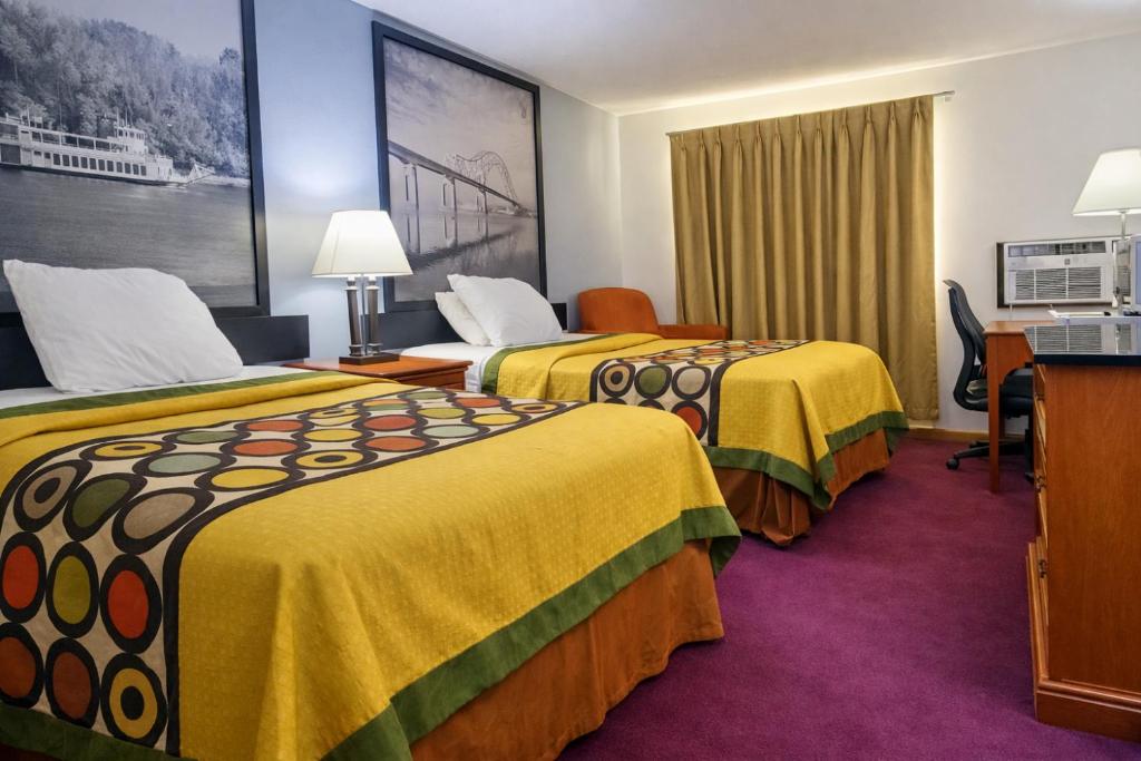 a hotel room with two beds and a desk at Algona Inn in Algona