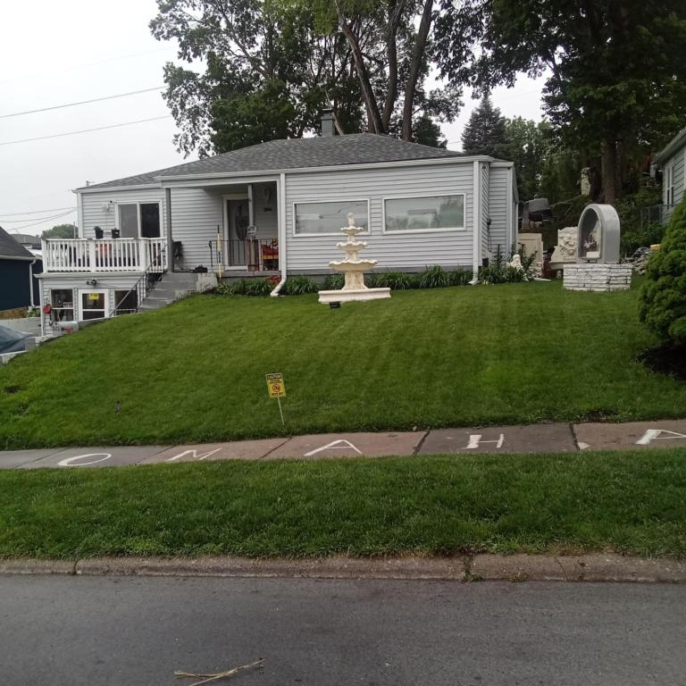 a house with a yard with a fountain in it at Cws seperate entrance in Omaha